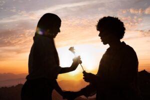 side view couple silhouettes posing with sky background min
